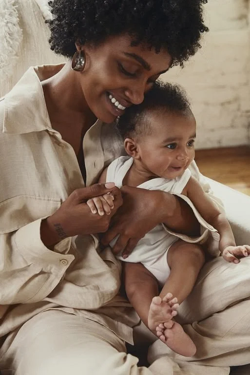 A mother cuddling her baby