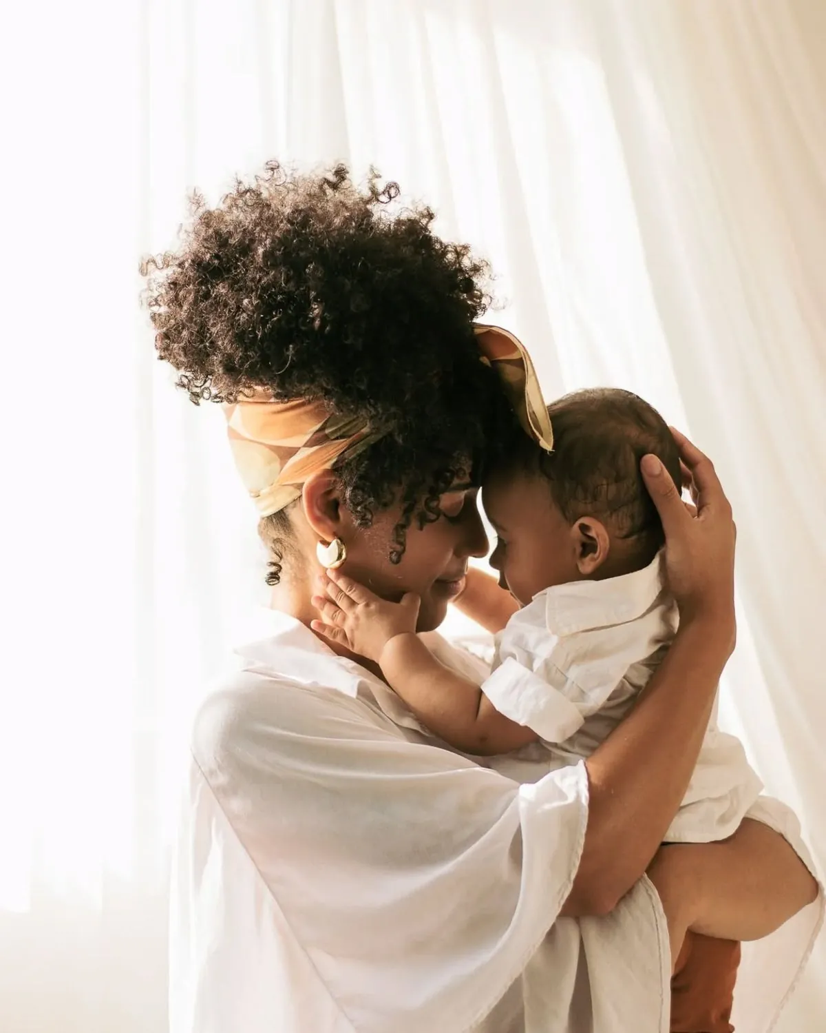 A mother holding her baby close