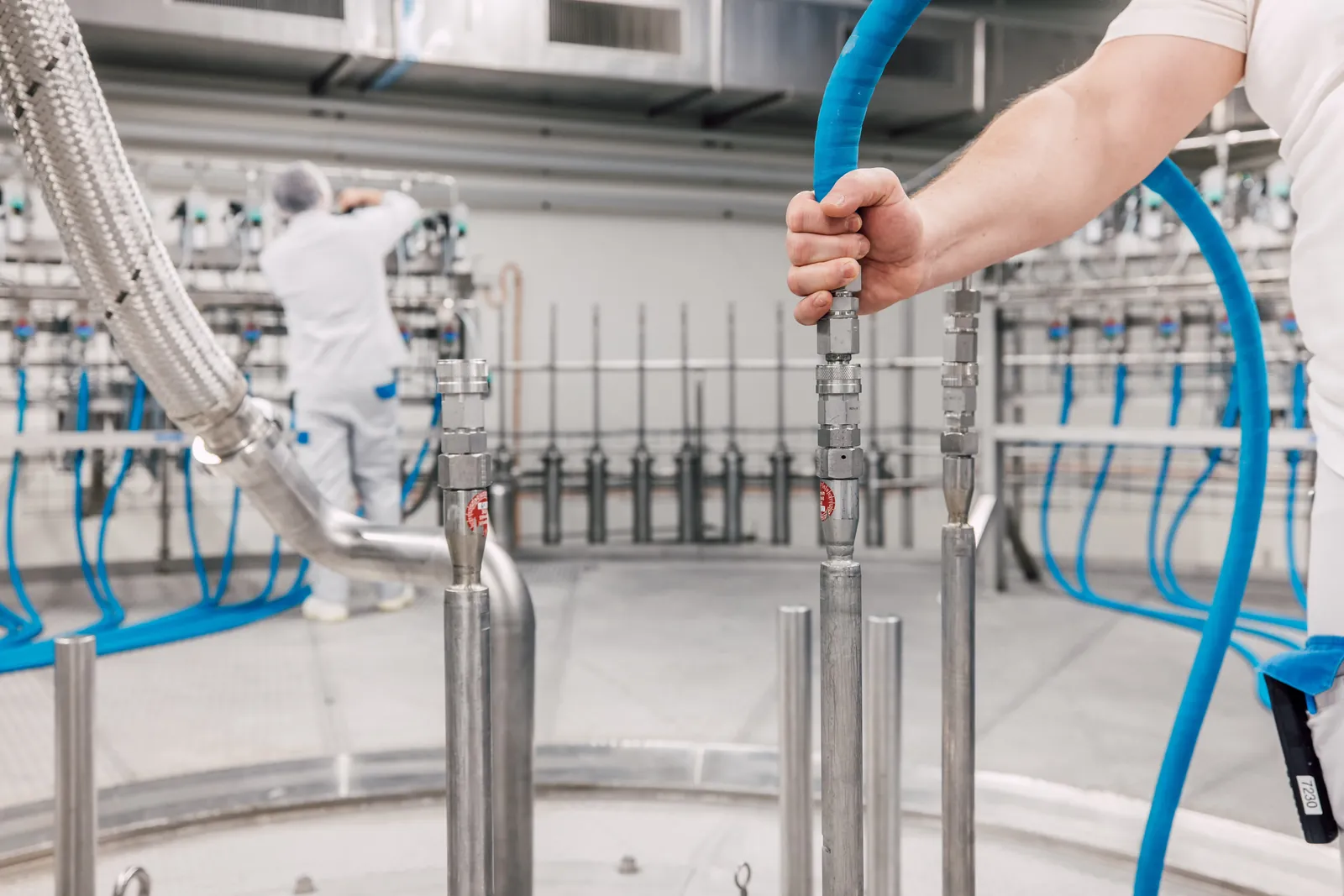 An operator connecting a line in liquid processing