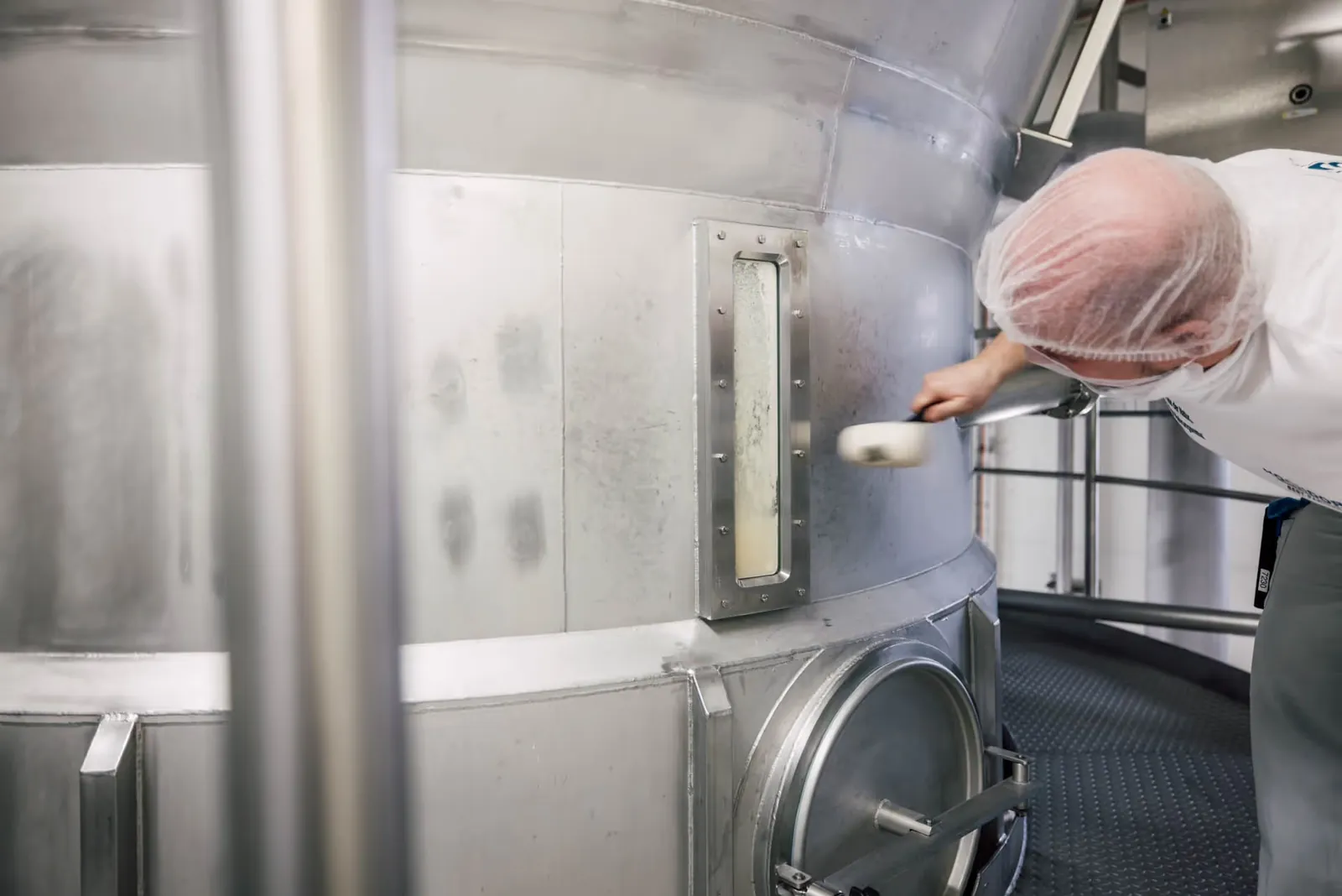 A HOCHDORF employee checking production equipment